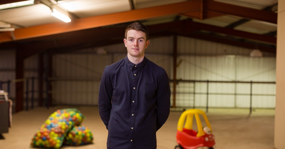 man in a warehouse with children's toys
